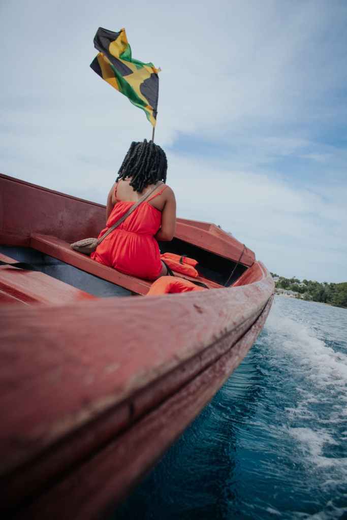 Where is the most affordable place to live in Jamaica? woman riding on a wooden boat