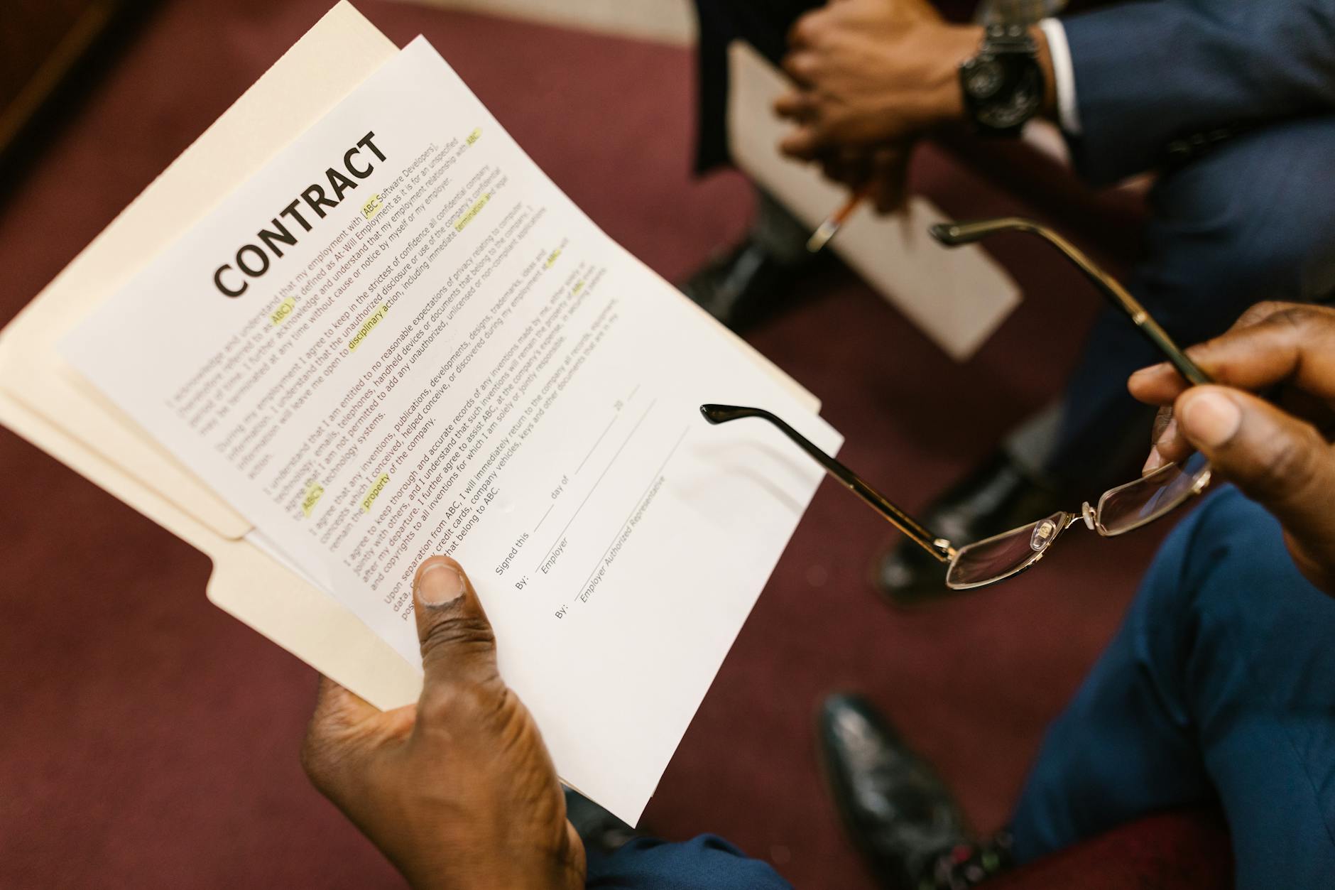 close up shot of a person holding a contract
