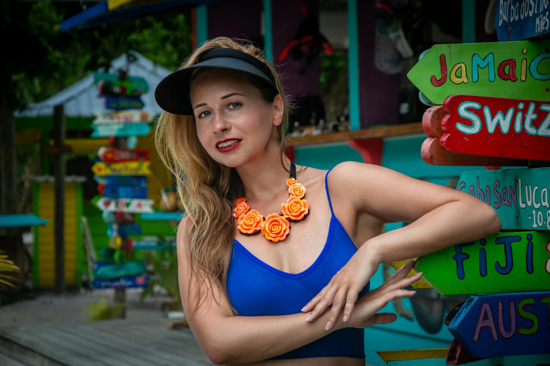 colorful caribbean scene with woman in blue top