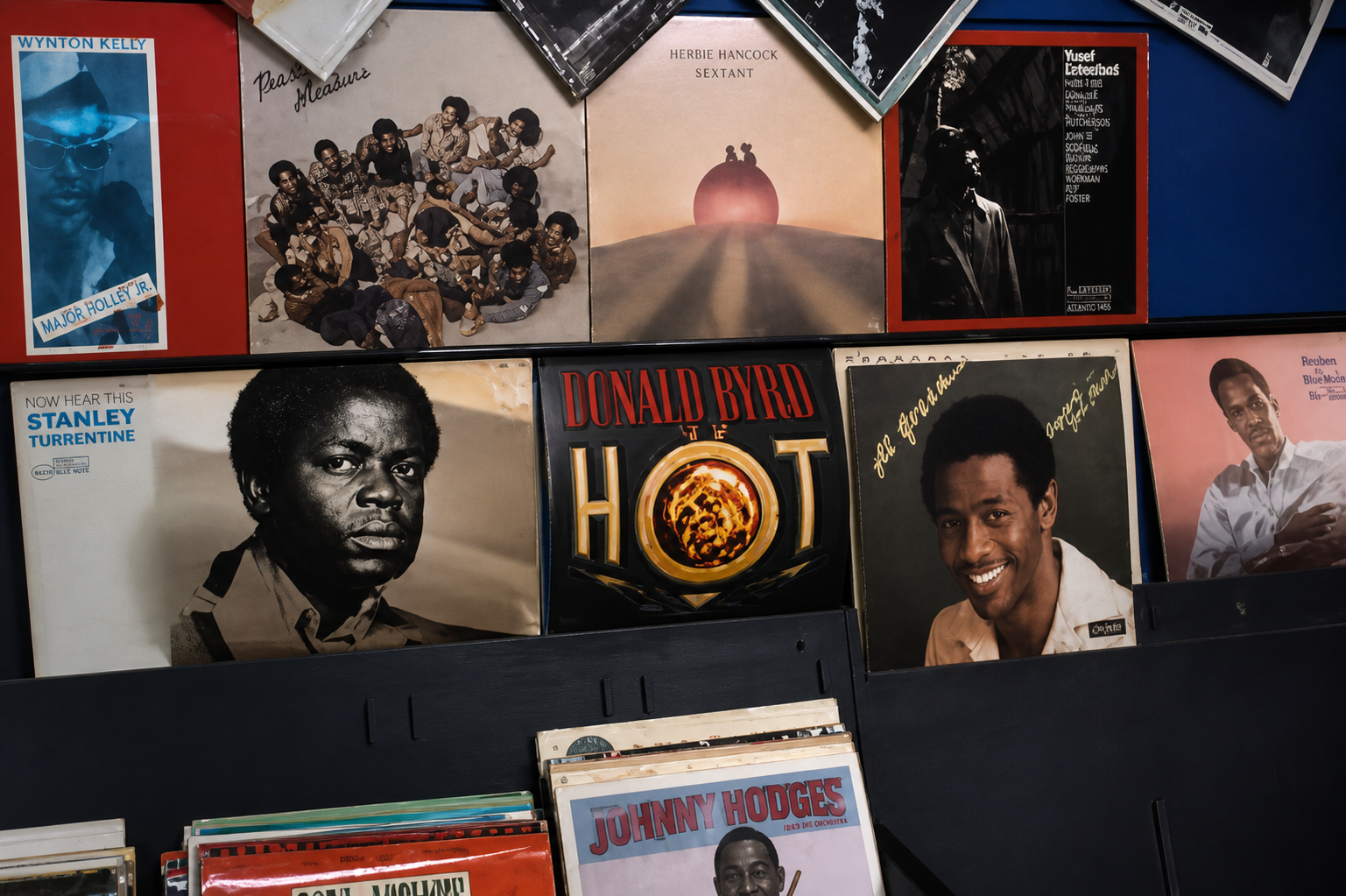 A record shop wall stacked with soul, jazz, and reggae releases reflects the soundscape of the Black diaspora, where music stores doubled as cultural hubs and community meeting points.