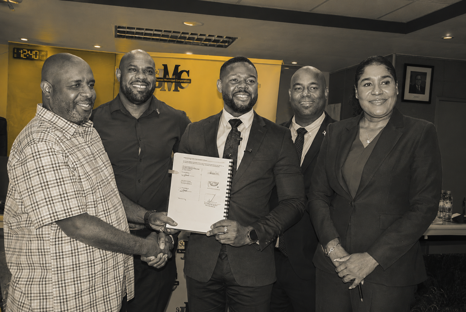 Mayor of Montego Bay Richard Vernon (centre) and Omar Thompson of Odel Allen Construction (left) shake hands following the signing of a contract for infrastructure work at Bogue Industrial Estate. Also in the photo are procurement officer at the St James Municipal Corporation Patrick Rhoden (second left); deputy mayor and councillor for the Spring Gardens Division Dwight Crawford; and the corporation’s chief executive officer Naudia Crosskill.