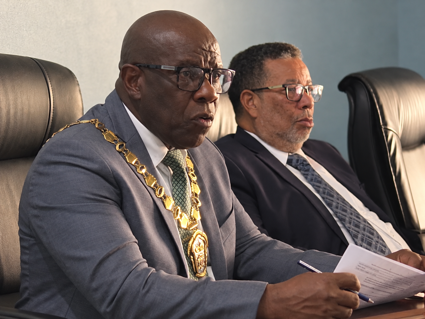 Mayor of Falmouth, Councillor C. Junior Gager (left), addresses the Trelawny Municipal Corporation’s regular monthly meeting on Thursday. Seated beside him is the corporation’s Chief Executive Officer.