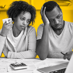 A couple review household bills and expenses, illustrating the financial pressure rising living costs, mortgages and everyday commitments can place on Jamaican families.