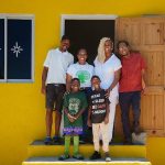 Theodore Notise and his twin sons with GrassROOTS Community Foundation officials, Senator Allan Bernard and a Flanker Resource Centre representative at the home handover in Flanker, St James