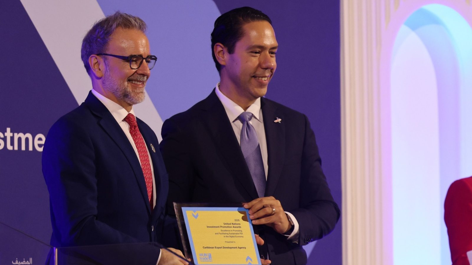 Leo Naut and Pedro Manuel Moreno hold Caribbean Export's United Nations Investment Promotion Award.