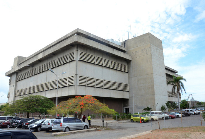 The concrete Central Sorting Office building on South Camp Road in Kingston, with cars parked in front