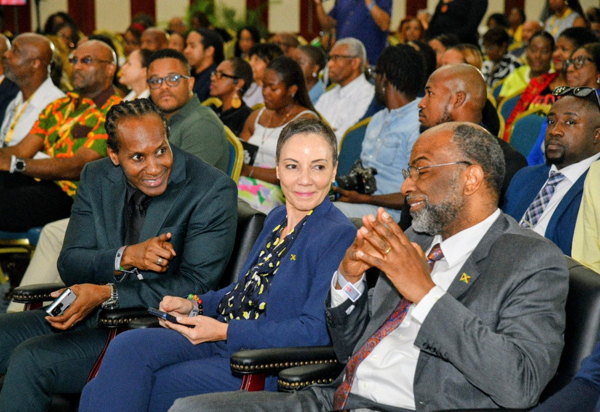 State Minister Alando Terrelonge speaks with Conference Chair Earl Jarrett at the 11th Biennial Jamaica Diaspora Conference in Montego Bay