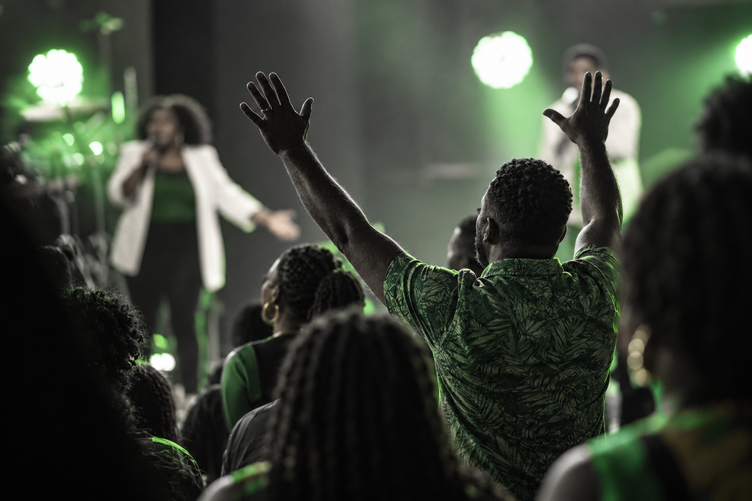 A worshipper raises both hands in praise during a lively church service, surrounded by fellow members of the congregation as gospel singers lead worship from the stage. The scene reflects the deep-rooted Christian traditions of Jamaica, where church gatherings continue to play an important role in community life, bringing people together through prayer, music, fellowship and shared faith. From traditional hymns to contemporary gospel worship, religious expression remains an enduring part of Jamaica’s cultural and spiritual identity. Illustrative image.