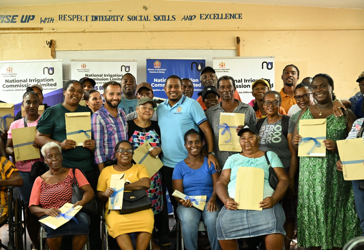 Farmers with land title documents at a July 2025 Pedro Plains ceremony in St Elizabeth