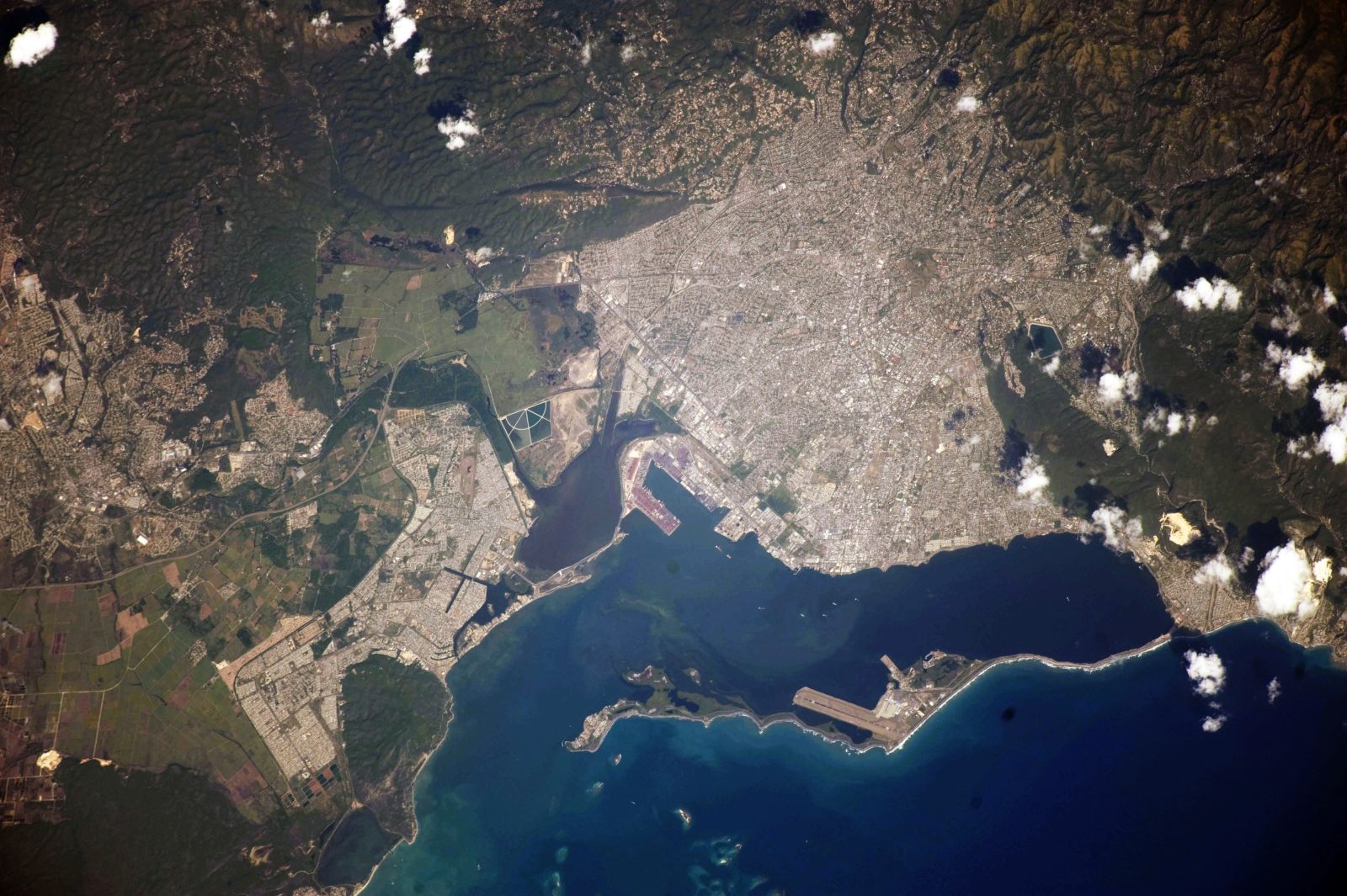 Satellite-style view of Kingston, Jamaica, showing the city spreading from the harbour into the surrounding hills