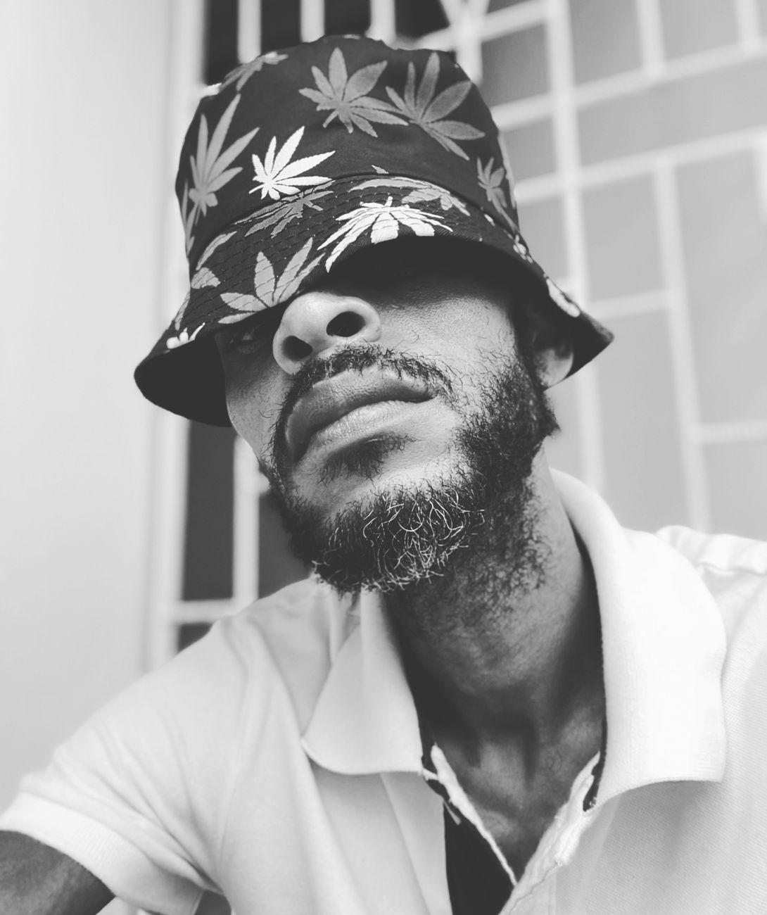 portrait of a man with a beard wearing a bucket hat