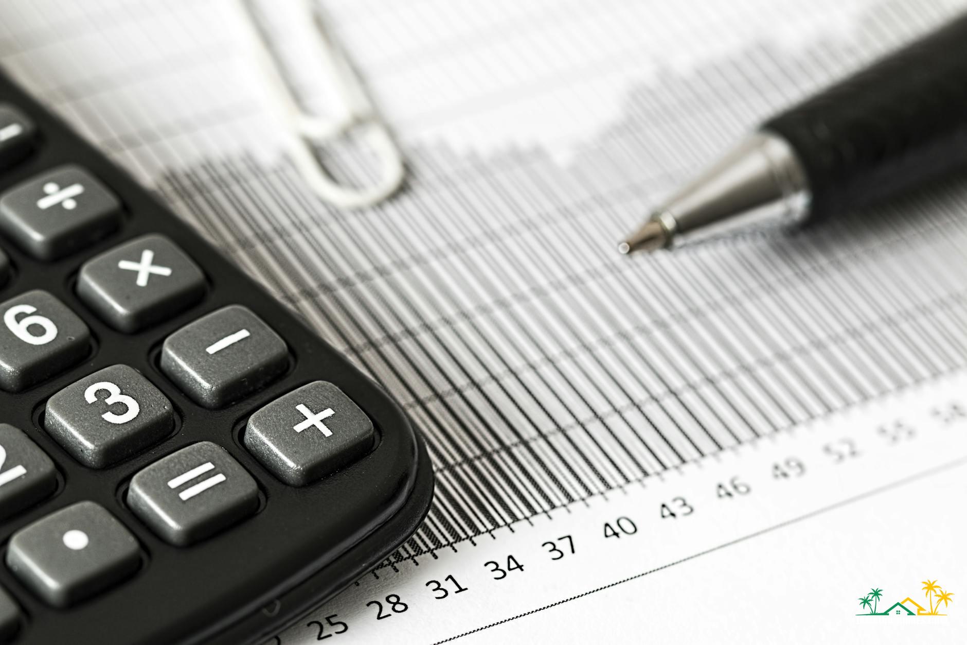 calculator and pen on table