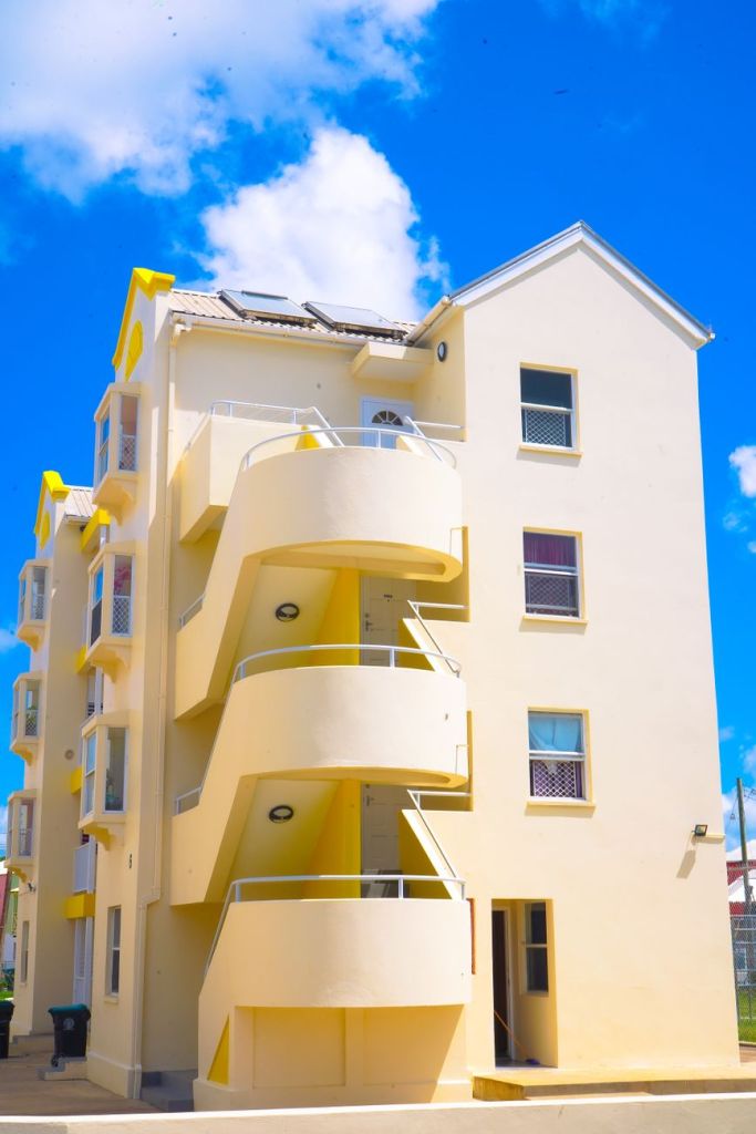 Barbados Widens Its Affordable Housing Net. A Model Worth Watching. modern apartment building in barbados