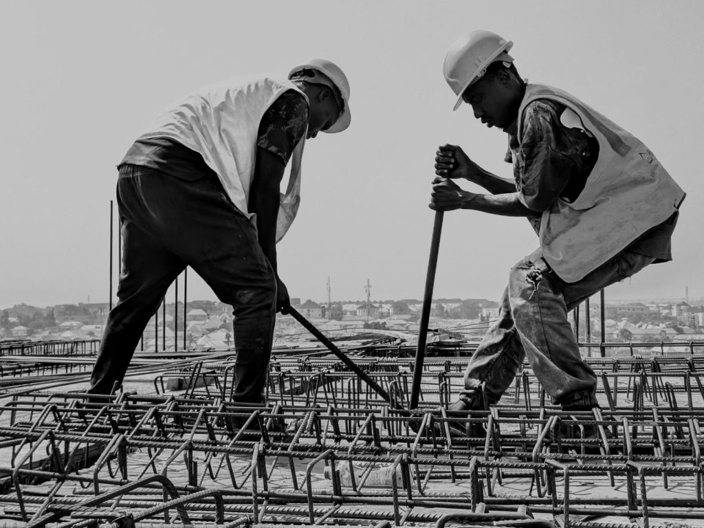 construction workers reinforcing steel bars on site - Photo by Mukhtar Shuaib
