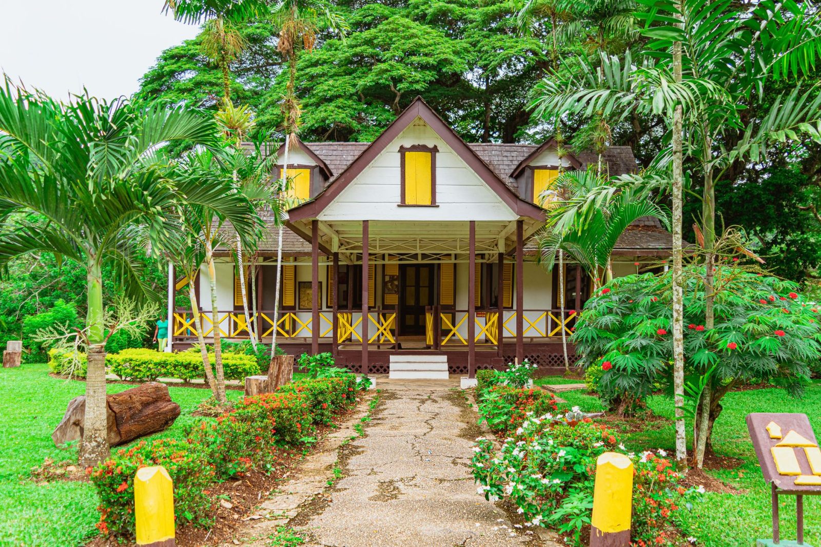 brown wooden house surrounded by green trees - Photo by Kenrick Baksh