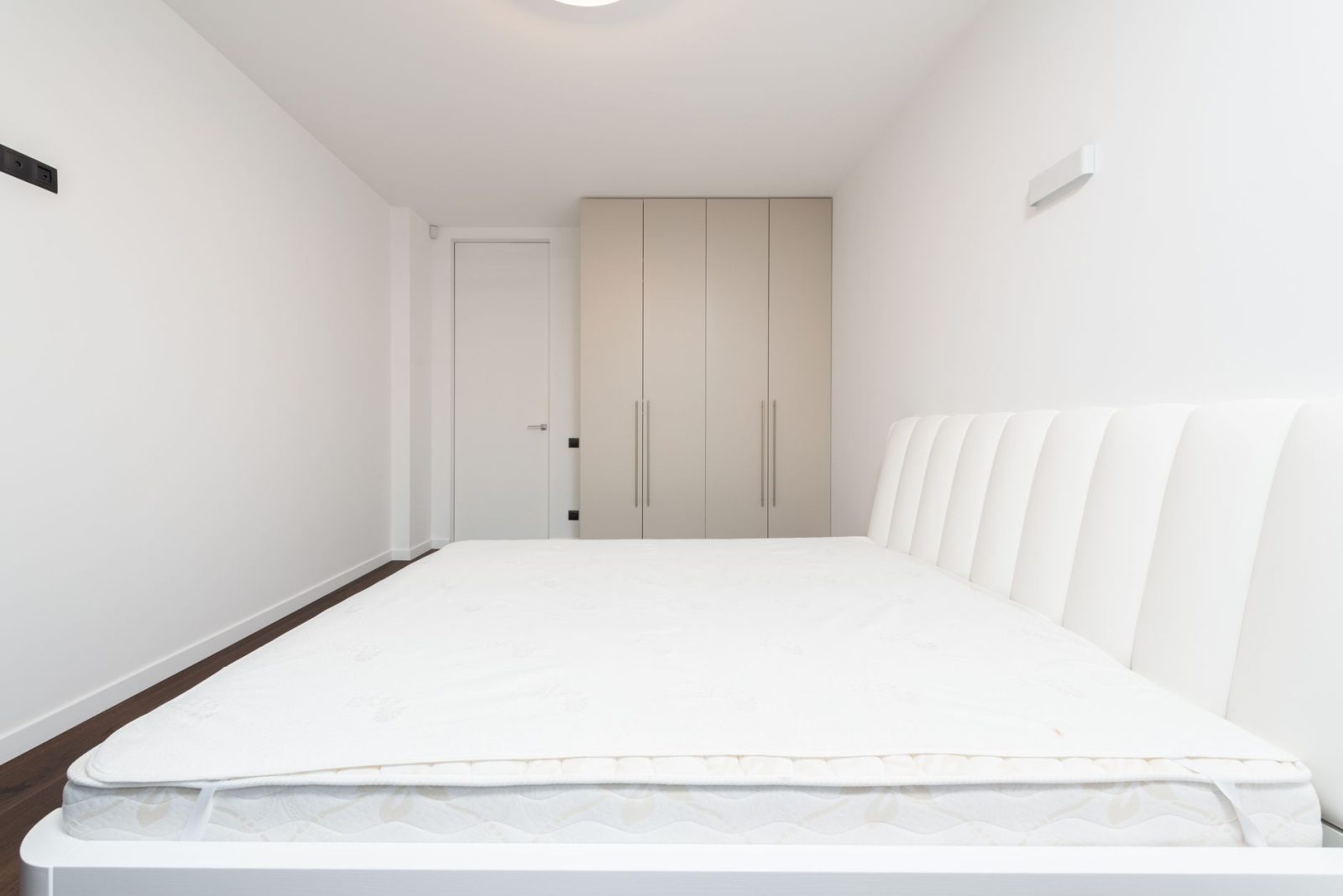 mattress on a white bed frame - Photo by Max Vakhtbovych