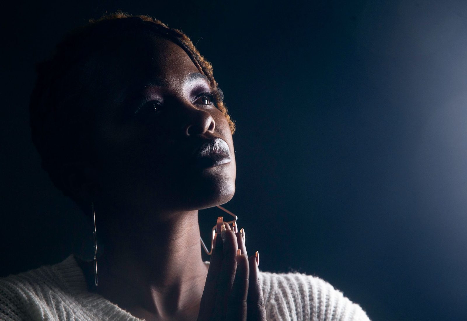 a woman with praying hands