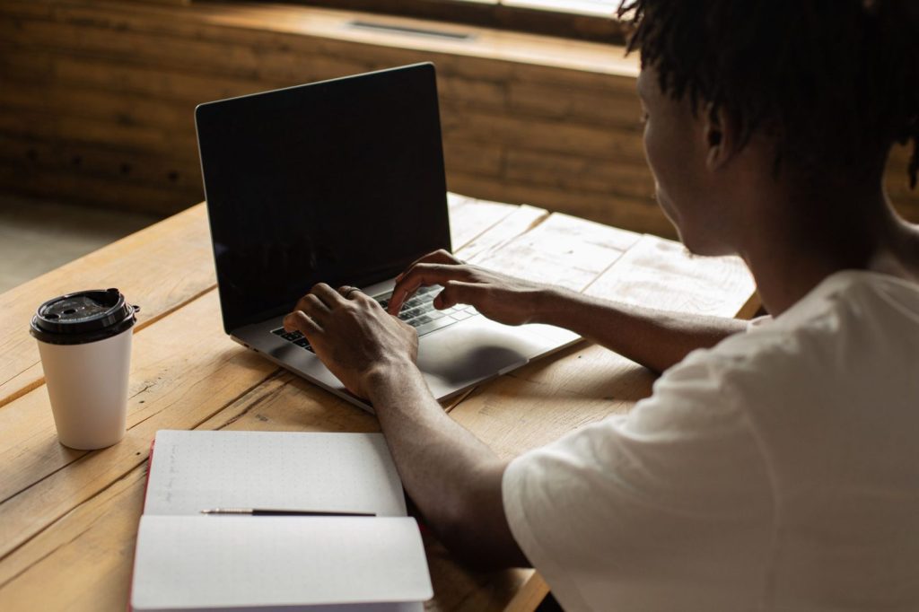 a man typing on a laptop - Photo by Monstera Production