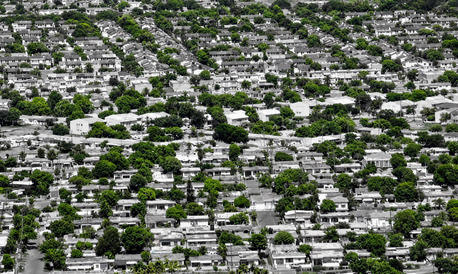 An aerial view of Portmore, St Catherine, showing the sprawling residential communities that have made the municipality one of Jamaica’s largest and most important urban housing centres. Illustrative image in Jamaica Homes’ signature green and grey style.